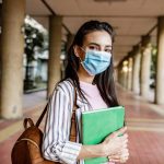 Student wearing a surgical mask to accompany article about research funding