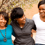 photo of three Black women linking arms