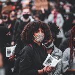 photo of woman of color wearing a face mask