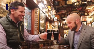 photo of two men drinking beer in a pub in Belfast, Ireland